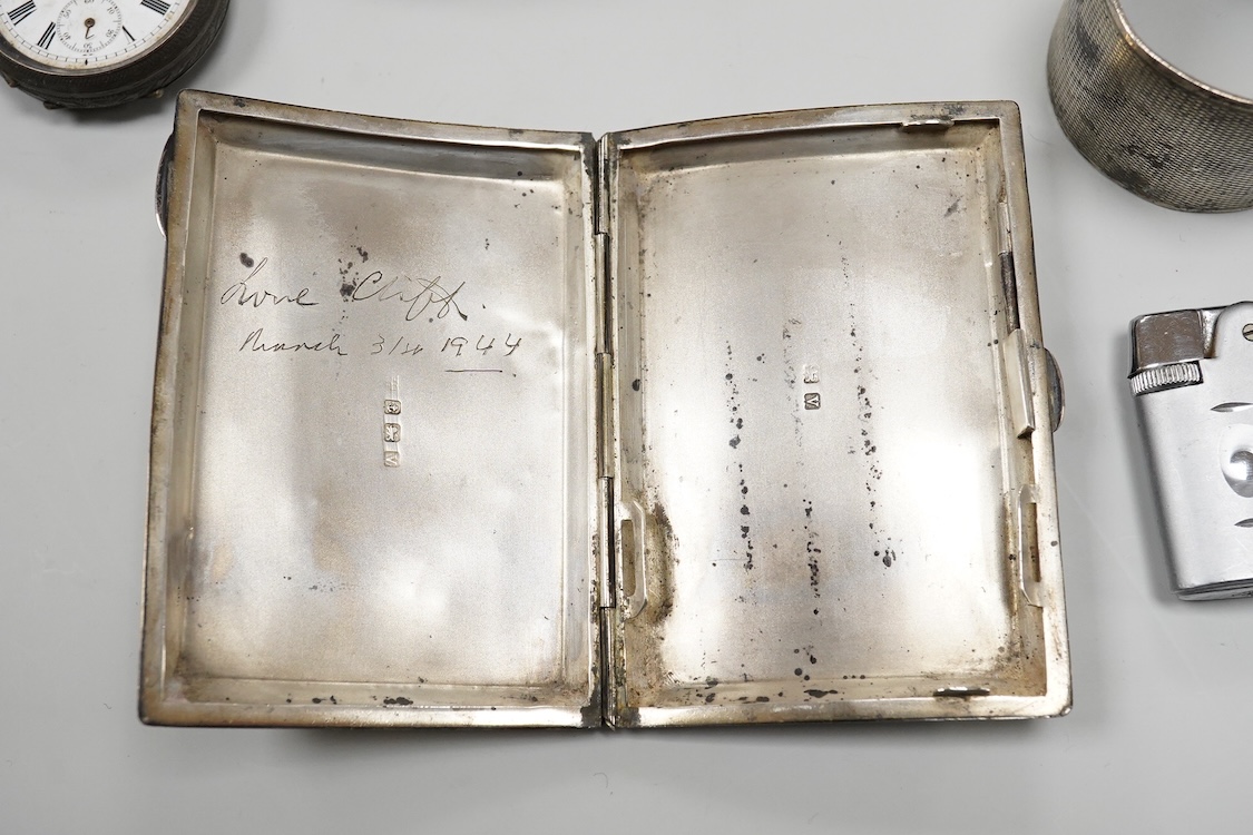 A collection of small silver to include a cigarette case, two napkin rings, three pairs of sugar tongs, a thimble, a lady's wrist watch and a mounted glass toilet jar. together with a 925 fob watch, a 935 mounted lighter